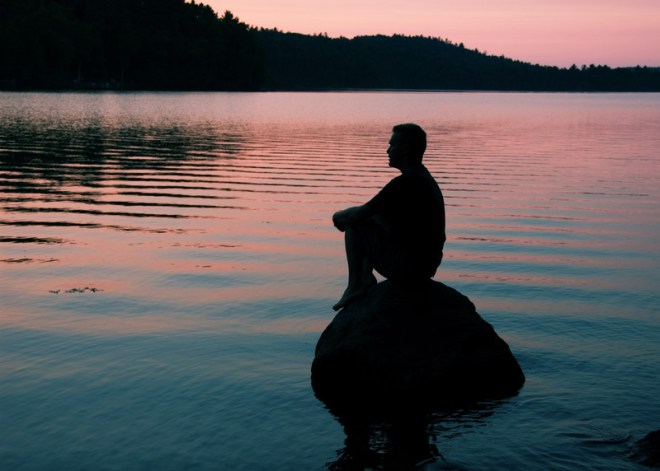 Man on rock meditating